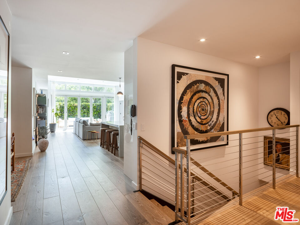 9000 West 3rd Street, Unit 103 Los Angeles, CA 90048 - Photo 15 of 27 a view of a livingroom with furniture wooden floor and a clock