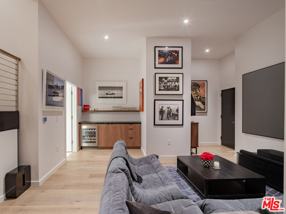 9000 West 3rd Street, Unit 103 Los Angeles, CA 90048 - Photo 18 of 27 a living room with furniture and a flat screen tv