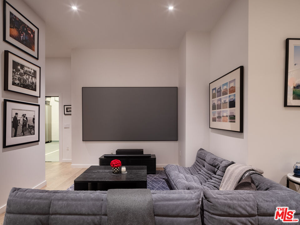 9000 West 3rd Street, Unit 103 Los Angeles, CA 90048 - Photo 19 of 27 a living room with furniture and a flat screen tv