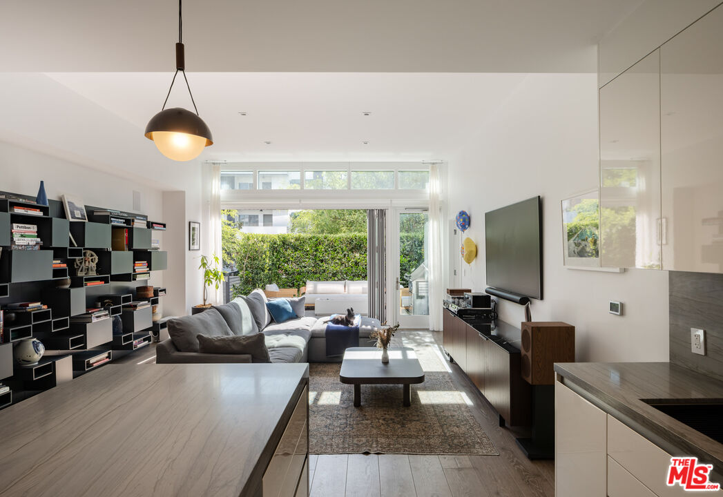 9000 West 3rd Street, Unit 103 Los Angeles, CA 90048 - Photo 2 of 27 a living room with furniture and a flat screen tv