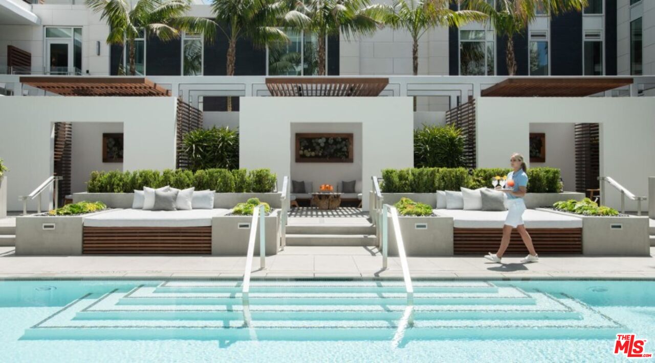 9000 West 3rd Street, Unit 103 Los Angeles, CA 90048 - Photo 26 of 27 a view of a house with a couches and a fireplace