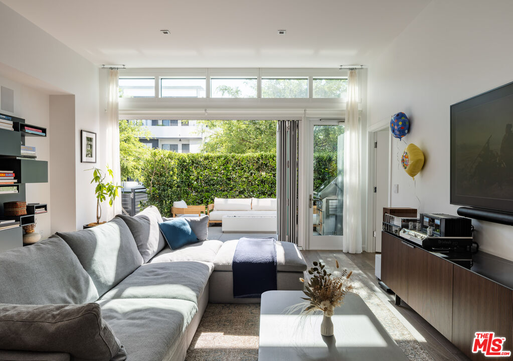 9000 West 3rd Street, Unit 103 Los Angeles, CA 90048 - Photo 5 of 27 a living room with furniture and a flat screen tv