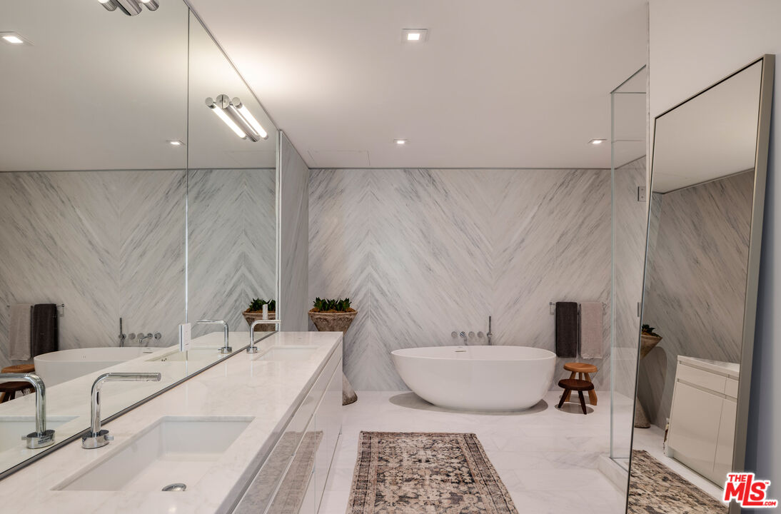 9000 West 3rd Street, Unit 103 Los Angeles, CA 90048 - Photo 9 of 27 a bathroom with a double vanity sink and a mirror