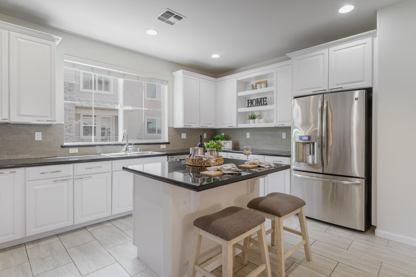 862 White Moonstone Loop San Jose, CA 95123 - Photo 10 of 54 a kitchen with stainless steel appliances granite countertop a refrigerator and a stove