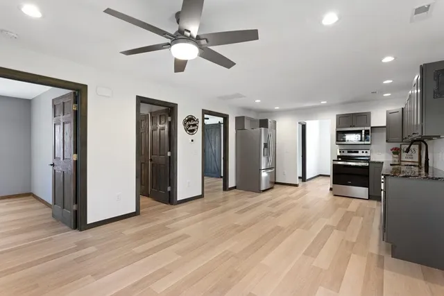 a view of a kitchen with a sink and a refrigerator