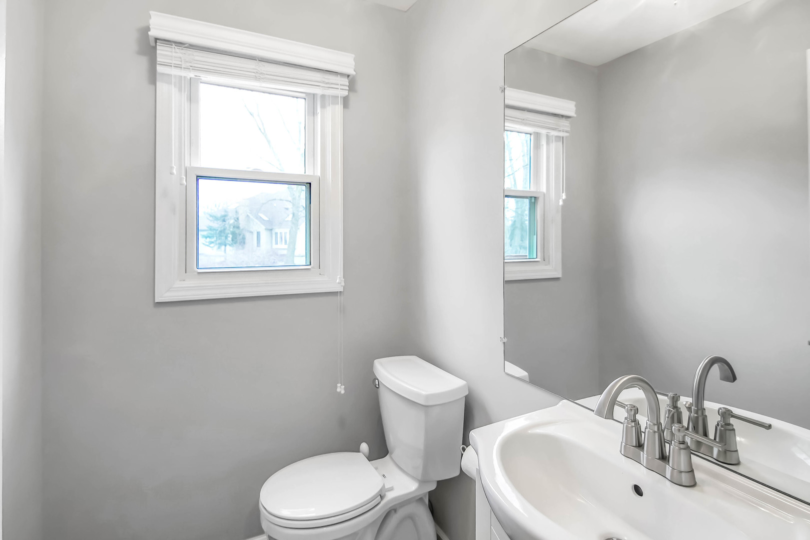 409 Delaware Circle Bolingbrook, IL 60440 - Photo 11 of 29 a white toilet sitting next to a bathroom sink
