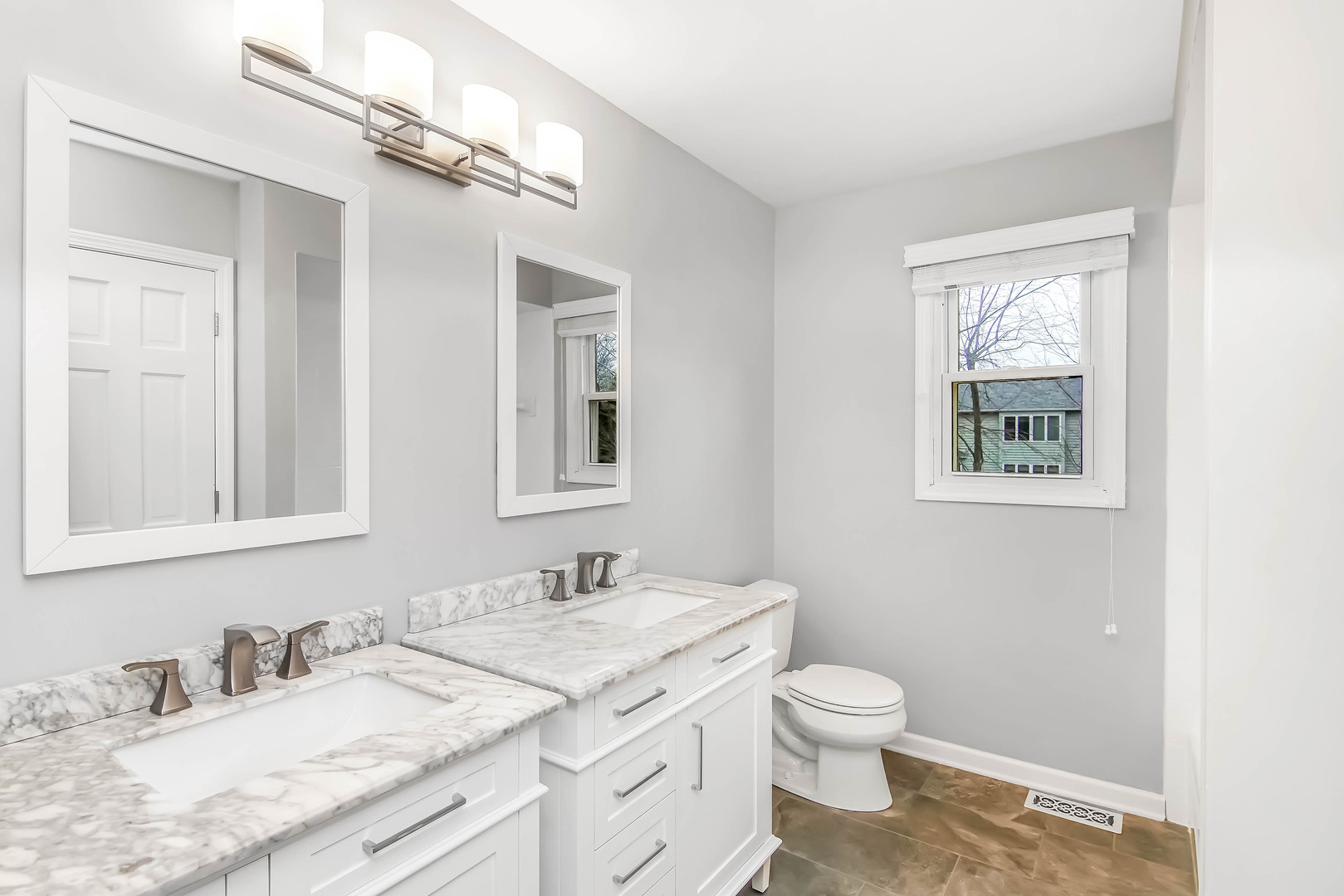 409 Delaware Circle Bolingbrook, IL 60440 - Photo 19 of 29 a bathroom with a granite countertop sink toilet a large mirror and a window