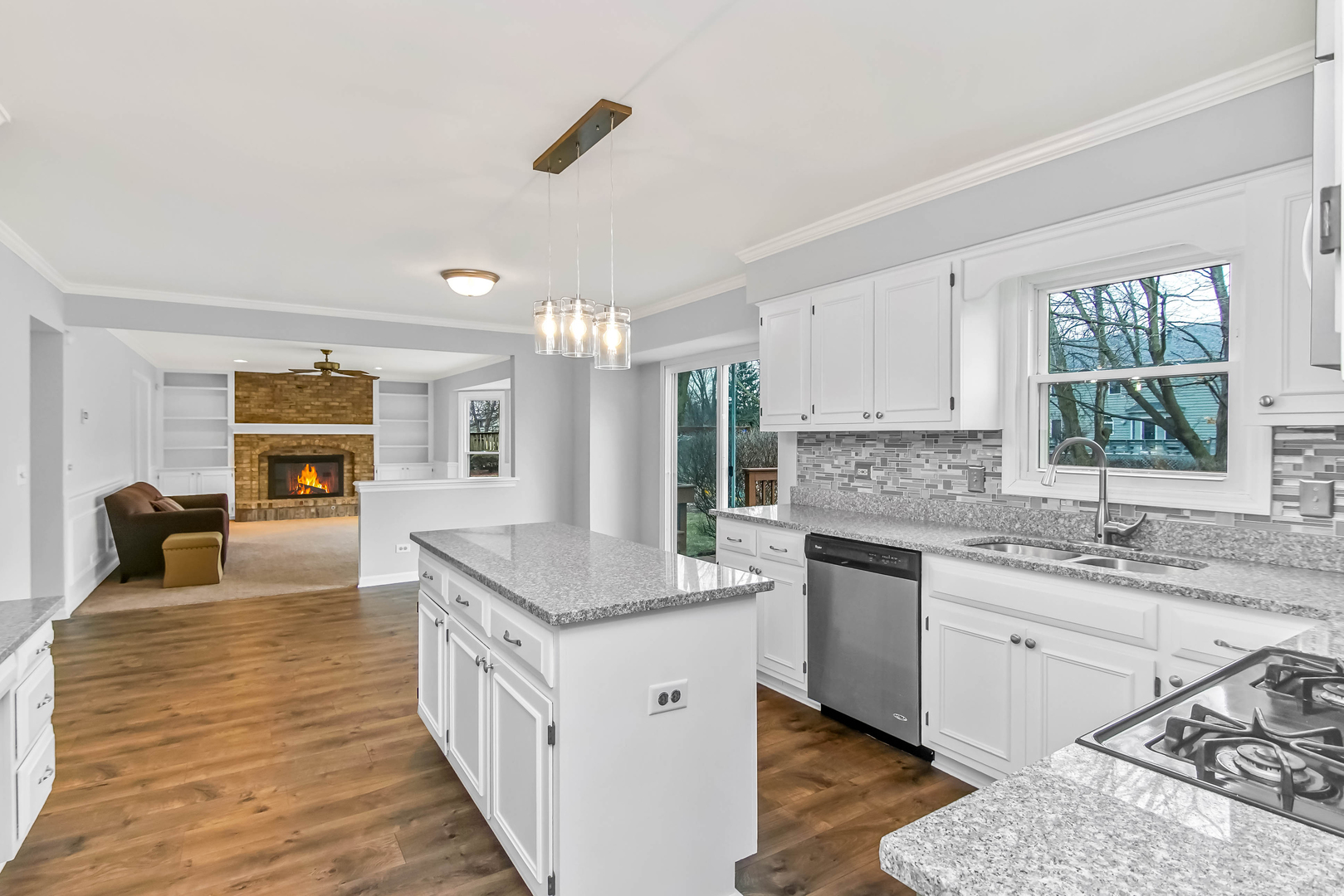 409 Delaware Circle Bolingbrook, IL 60440 - Photo 5 of 29 a kitchen with granite countertop a sink stove and cabinets