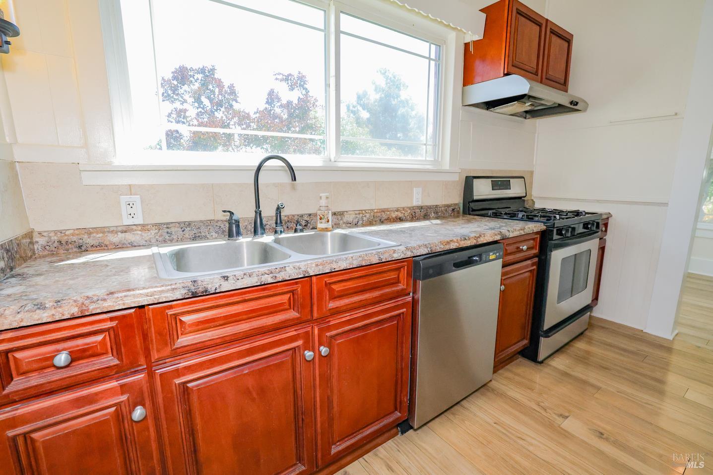 7948 North Meridian Road Dixon, CA 95620 - Photo 15 of 59 a kitchen with stainless steel appliances granite countertop a sink and a stove