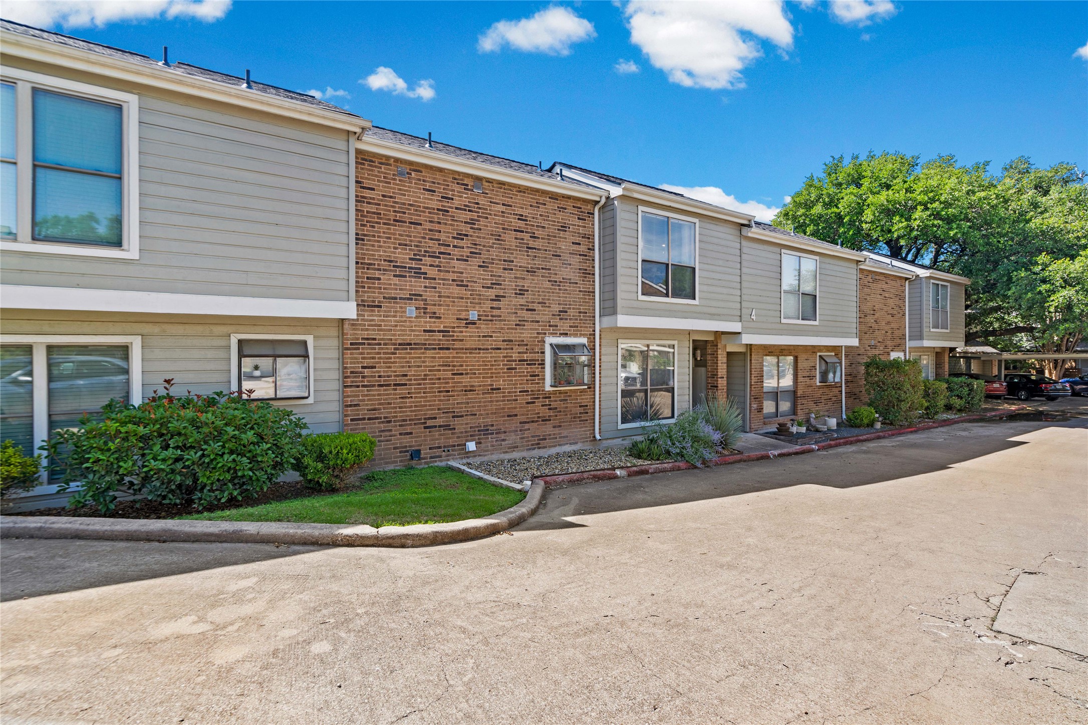 2018 West Rundberg Lane, Unit 4B Austin, TX 78758 - Photo 25 of 28 a front view of a house with yard and a garage