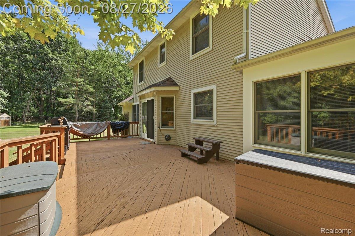 10100 Springtime Circle Clarkston, MI 48348 - Photo 68 of 73 Expansive wood deck with railing, siding exterior, multiple windows, and a glass sliding door