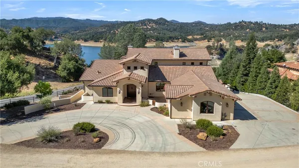 an aerial view of a house with a yard and potted plants