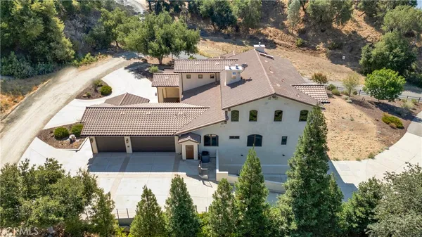 a view of house with yard and sitting area