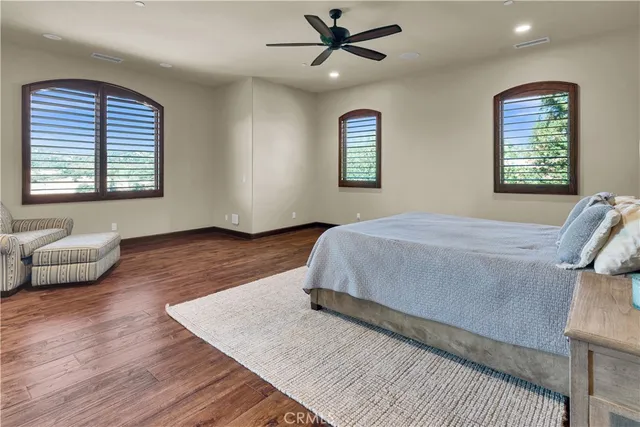 a bathroom with a granite countertop sink a toilet and a mirror