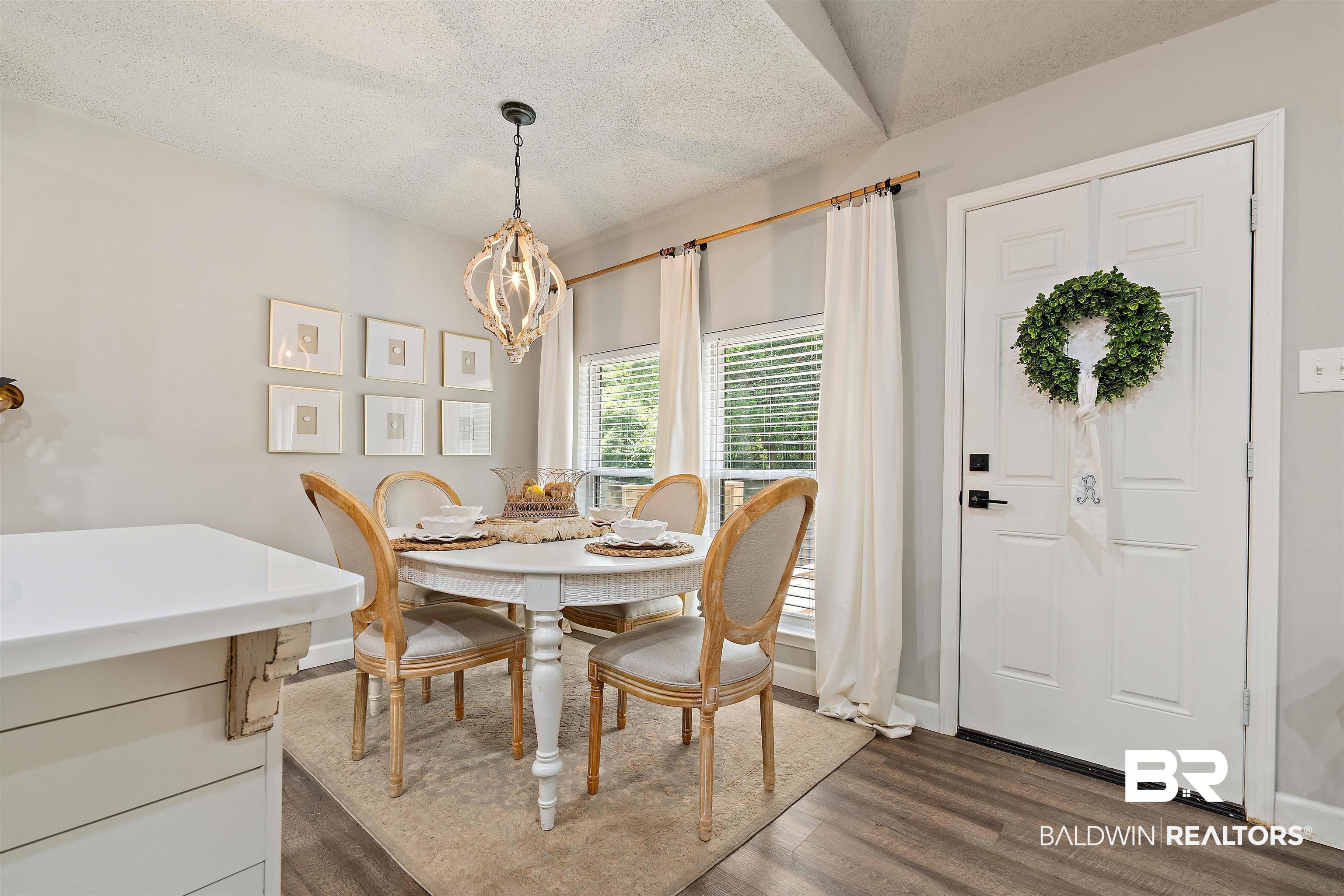 4682 Opal Drive Mobile, AL 36619 - Photo 8 of 27 Dining space with dark wood-type flooring, an inviting chandelier, and a textured ceiling