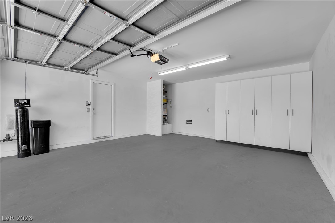 646 Monument Point Street Henderson, NV 89002 - Photo 31 of 44 Ample storage solutions elevate this functional and well-lit garage space.