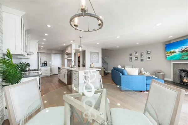a large kitchen with stainless steel appliances kitchen island a large counter top a sink a stove and a refrigerator