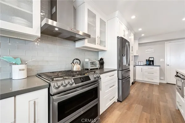 a kitchen with stainless steel appliances a refrigerator sink and microwave