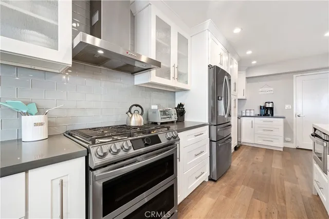 a kitchen with stainless steel appliances a refrigerator sink and microwave