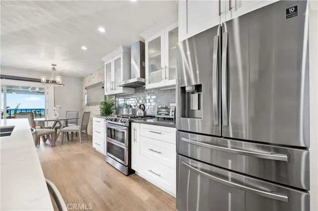 a bedroom with a large bed and chandelier