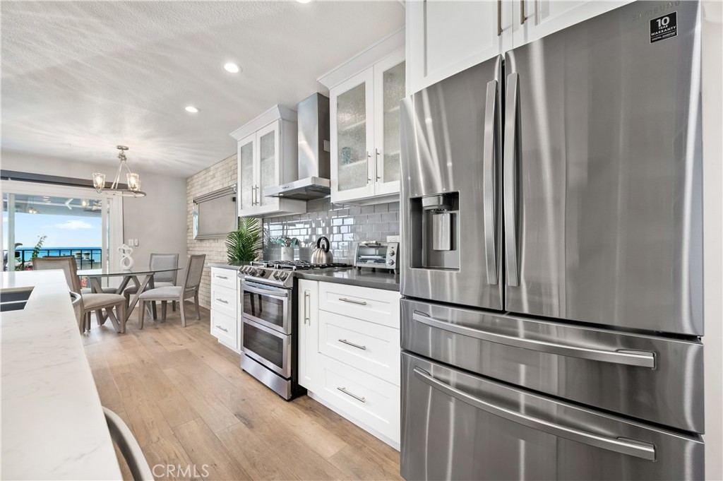 25872 Vista Drive West Dana Point, CA 92624 - Photo 21 of 75 a kitchen with stainless steel appliances white cabinets and a refrigerator