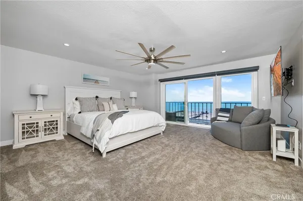 a bedroom with a large bed and a large window