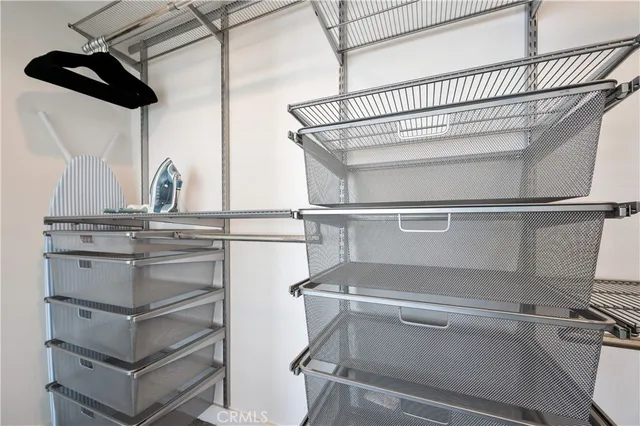 a bedroom with a bed a couch and a window