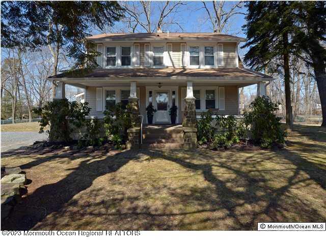62 Church Road Howell, NJ 07731 - Photo 2 of 23 a view of a white house with large windows and a small yard
