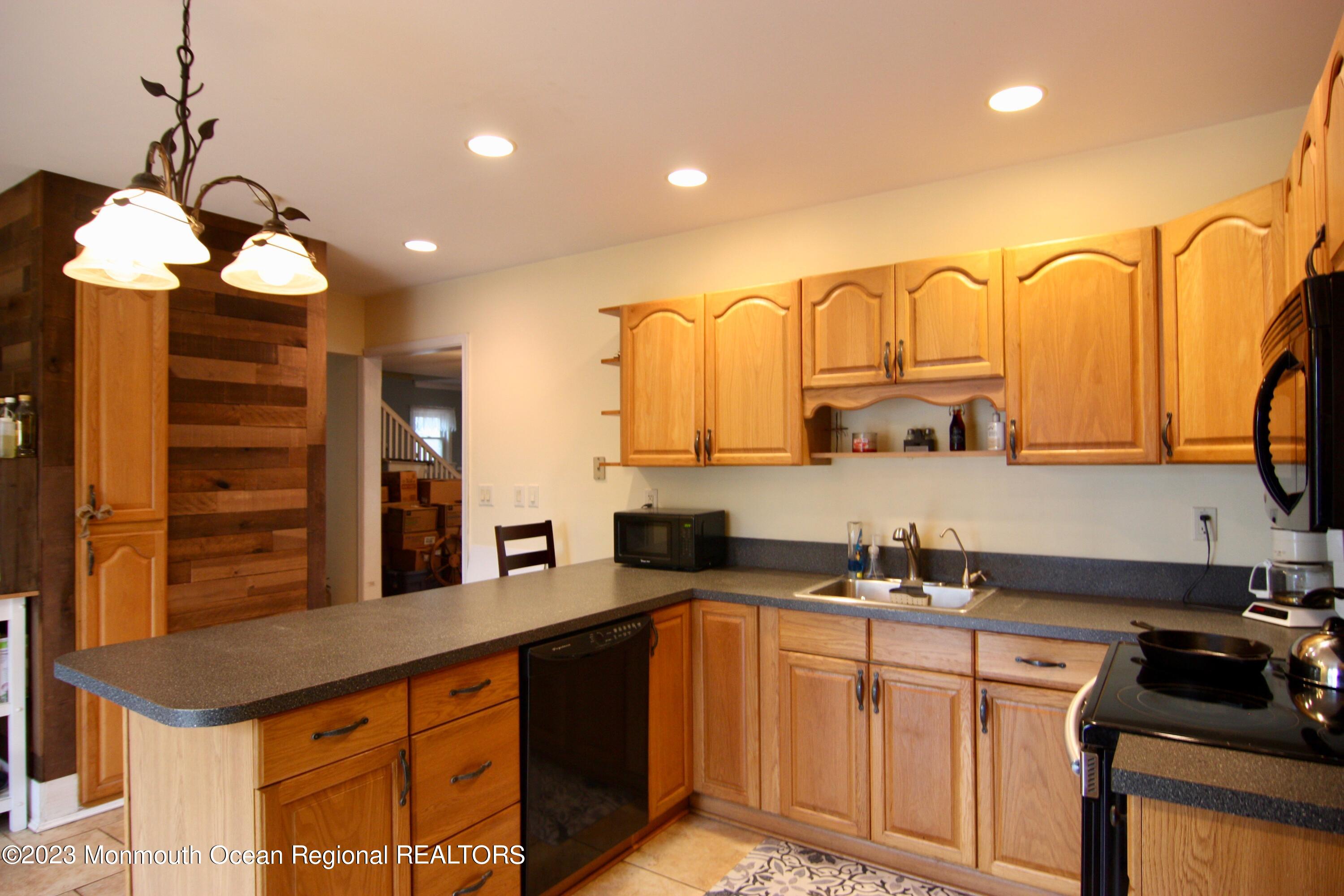 62 Church Road Howell, NJ 07731 - Photo 3 of 23 a kitchen with stainless steel appliances granite countertop a sink a stove and a wooden cabinets