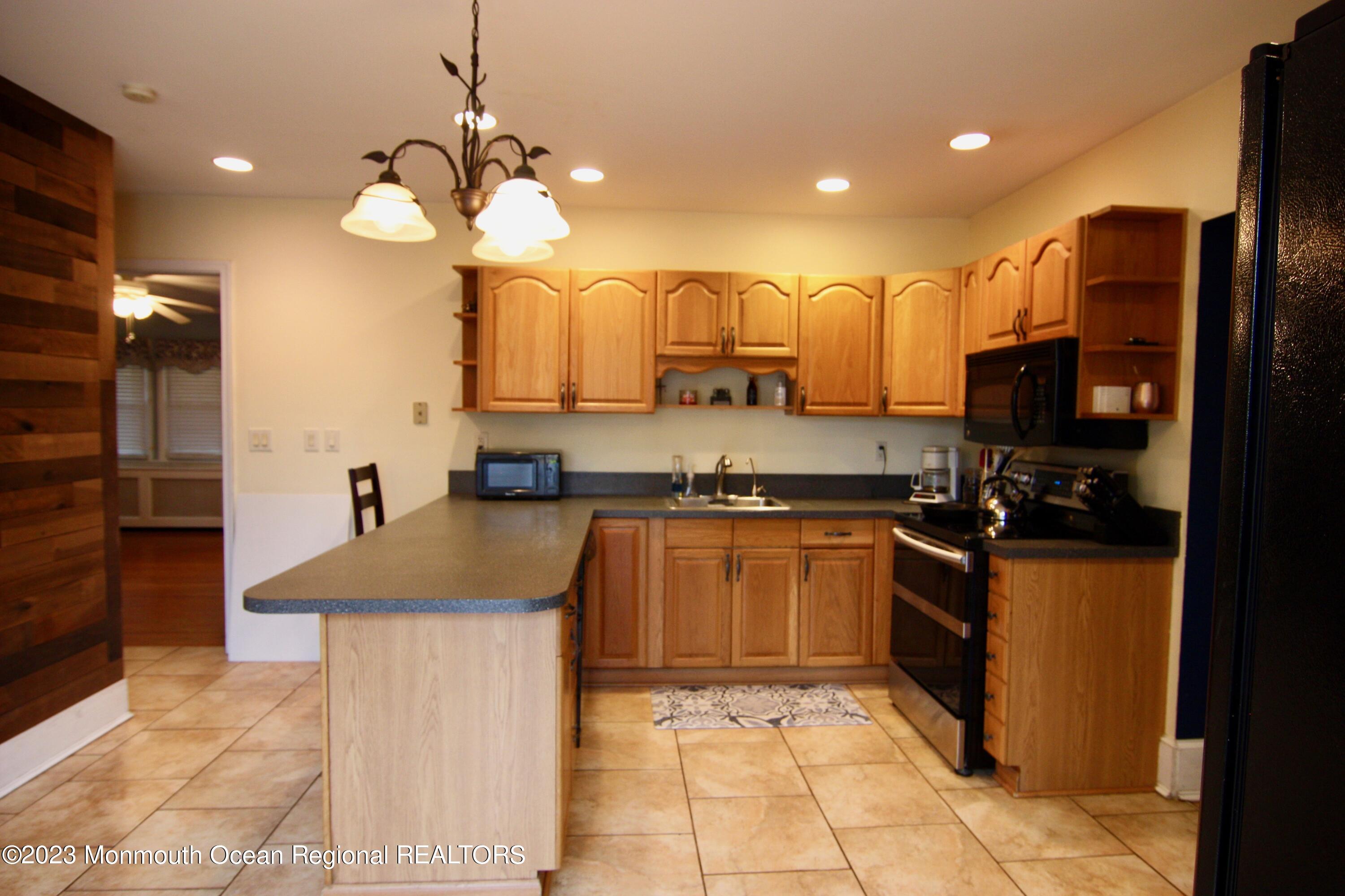 62 Church Road Howell, NJ 07731 - Photo 5 of 23 a kitchen with stainless steel appliances granite countertop a sink counter space cabinets and a stove top oven