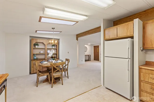 a dining room with furniture and a refrigerator