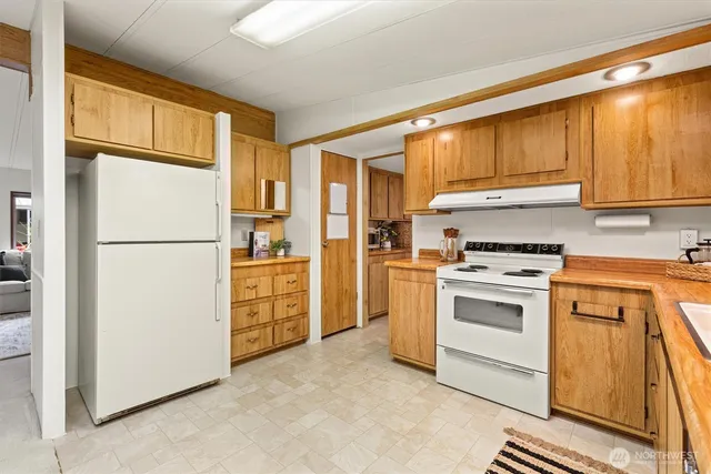 a kitchen with appliances cabinets and a refrigerator