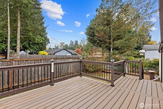 a view of balcony with wooden floor and fence