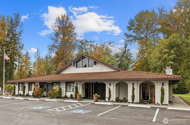 a view of a white house with a outdoor space