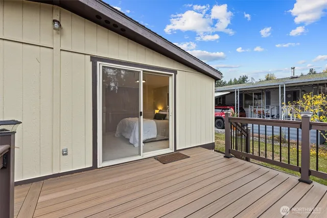 a view of an outdoor space with wooden floor and windows
