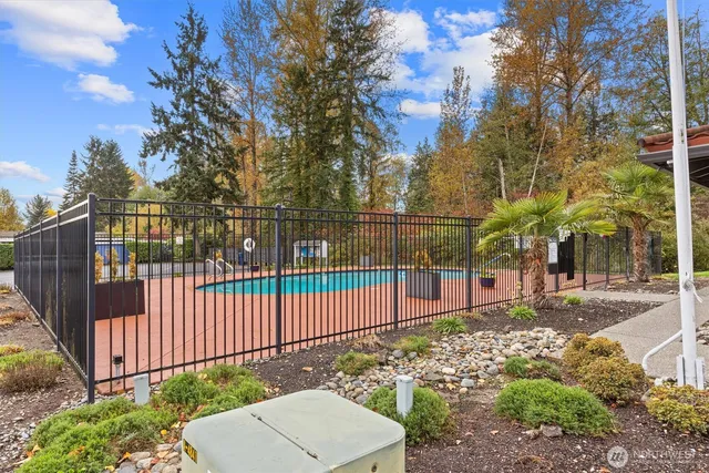a view of a backyard with wooden fence