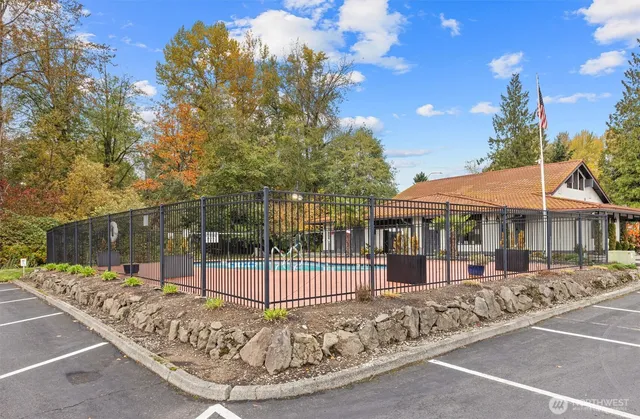 a view of a house with a small yard and potted plants