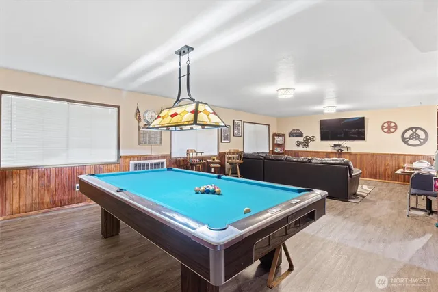a room with pool table and a chandelier