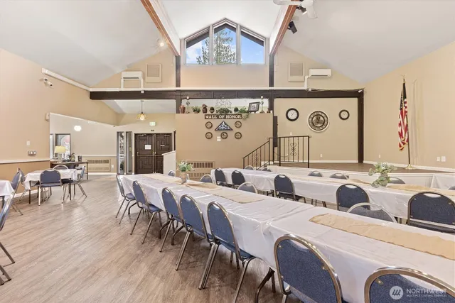 a dinning area with furniture and wooden floor