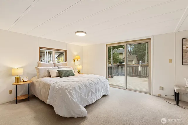 a bedroom with a bed and a night stand