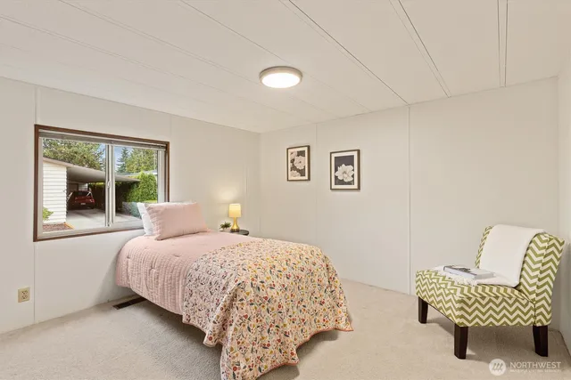 a bedroom with a bed and chair