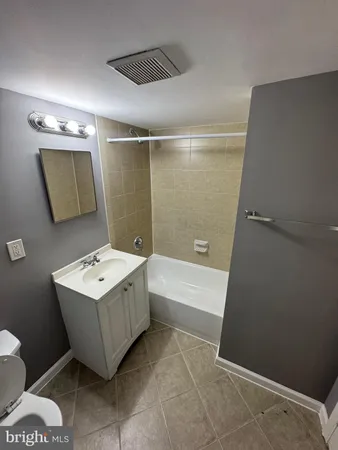 a bathroom with a sink a toilet and bathtub