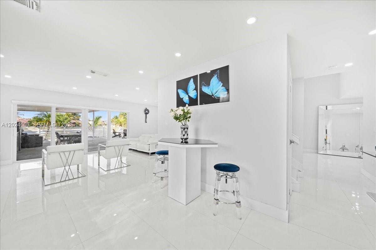 15341 Southwest 36th Street Miami, FL 33185 - Photo 10 of 56 an open dining room with furniture and a floor to ceiling window