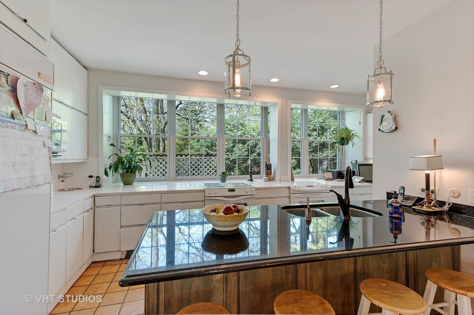 1206 Tower Road Winnetka, IL 60093 - Photo 5 of 19 a kitchen with a large window and cabinets