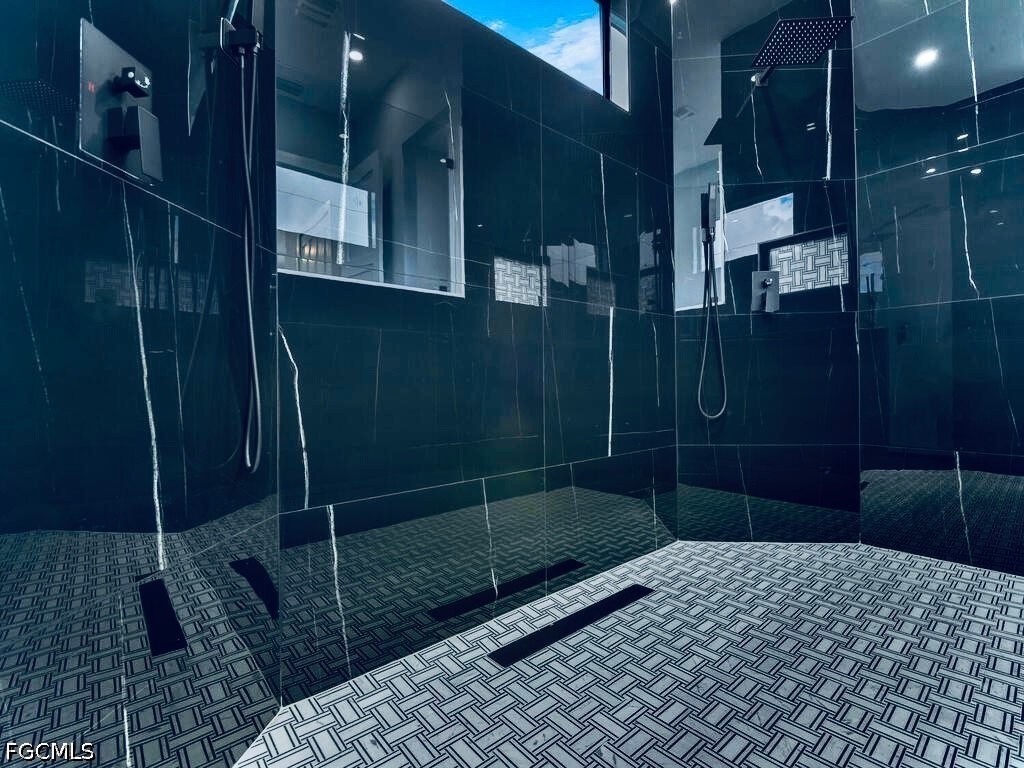 3517 2nd Street Southwest Lehigh Acres, FL 33976 - Photo 13 of 28 a bathroom with a shower