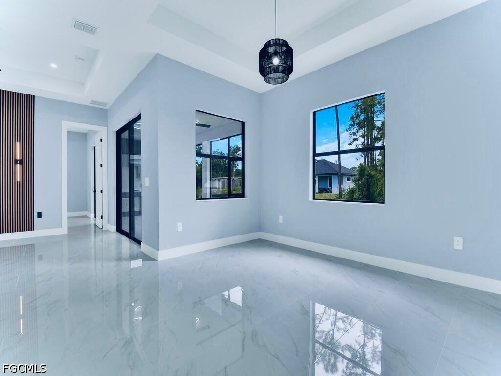 3517 2nd Street Southwest Lehigh Acres, FL 33976 - Photo 20 of 28 an empty room with windows and fan