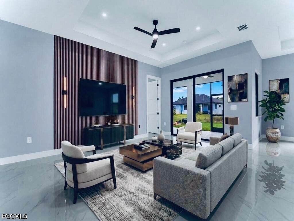 3517 2nd Street Southwest Lehigh Acres, FL 33976 - Photo 2 of 28 a living room with furniture and a flat screen tv