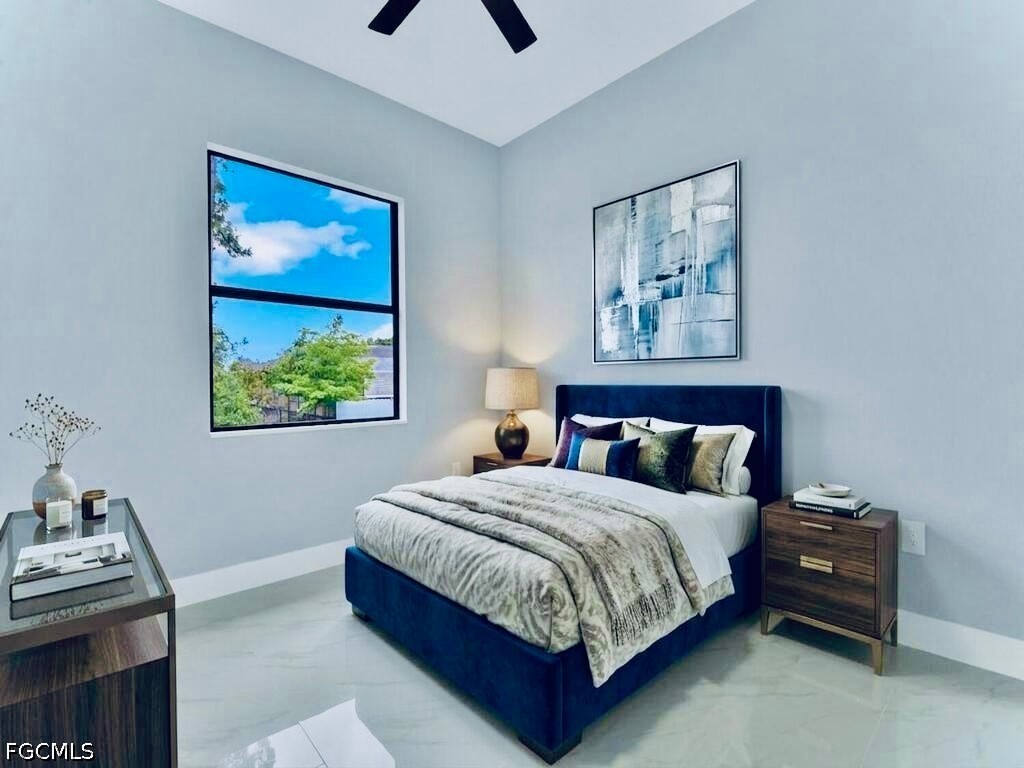 3517 2nd Street Southwest Lehigh Acres, FL 33976 - Photo 21 of 28 a bedroom with a bed and a window