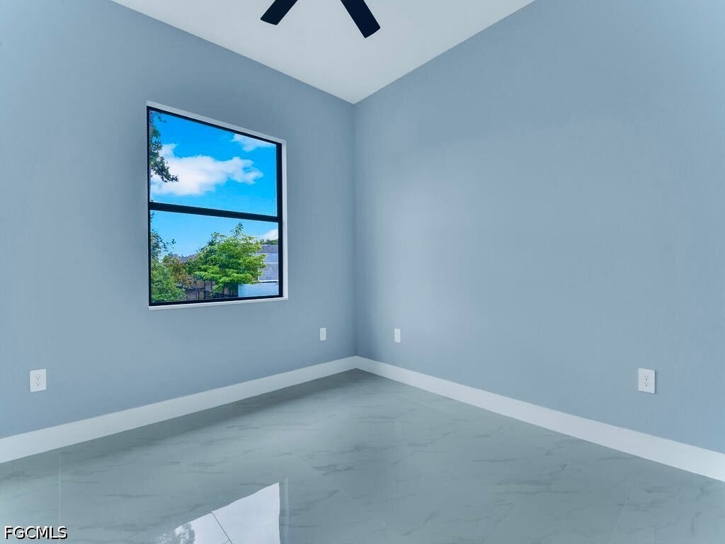 3517 2nd Street Southwest Lehigh Acres, FL 33976 - Photo 22 of 28 an empty room with windows