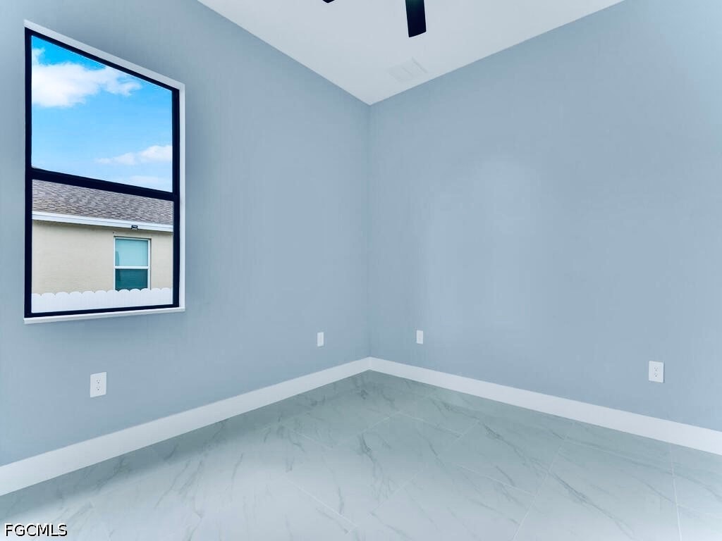 3517 2nd Street Southwest Lehigh Acres, FL 33976 - Photo 25 of 28 a view of an empty room with a window